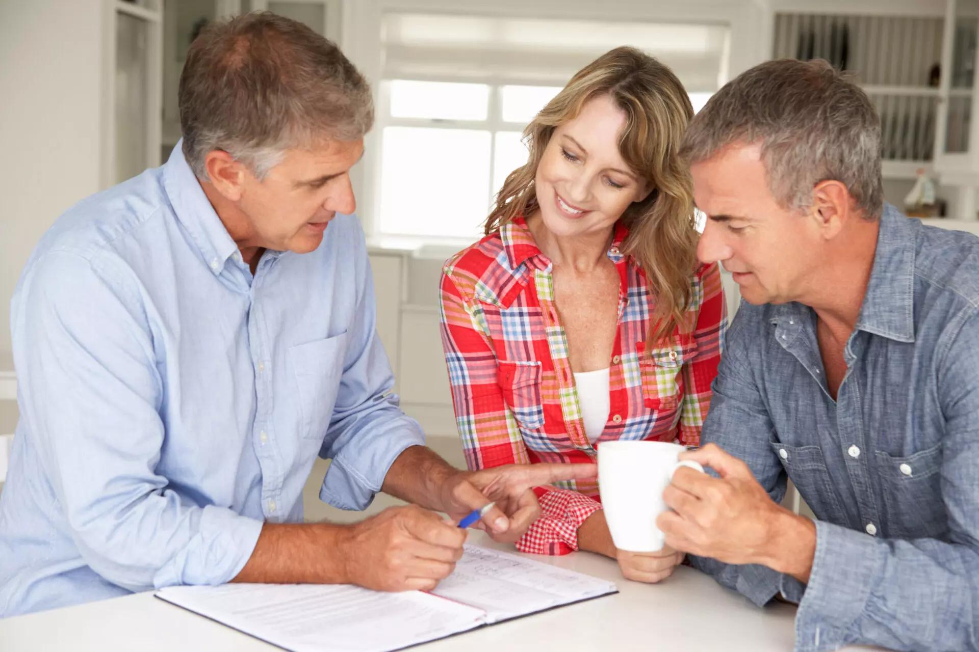 a financial advisor sits with clients to discuss non-cash asset giving