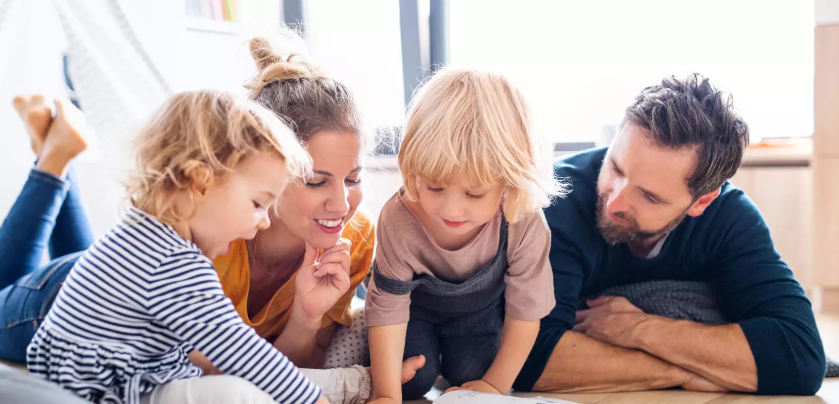 family of four on the floor creating their generosity plan