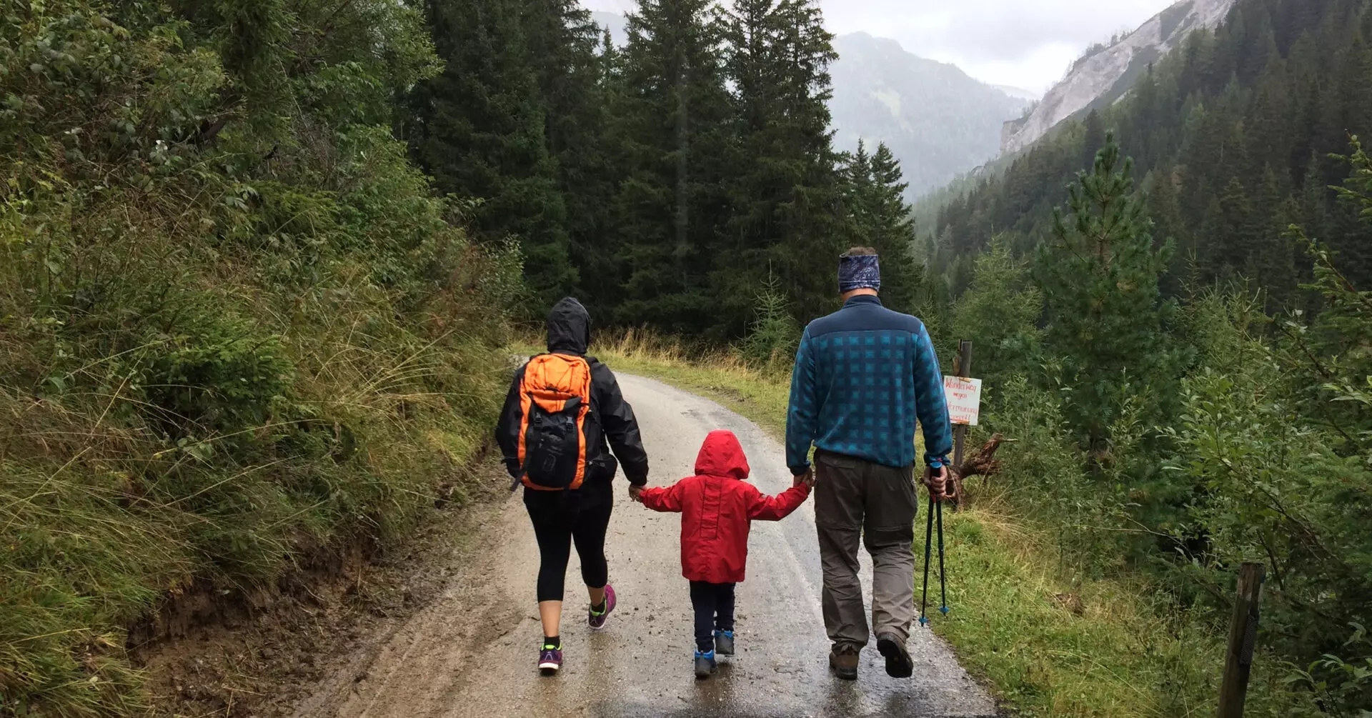 Family walks in the woods on a rainy day